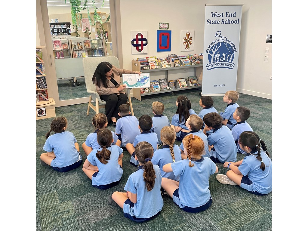 web-Minister Grace reading to students at West End SS A teacher exemplifying one of the 10 essential classroom management skills as her class is focused and organised.