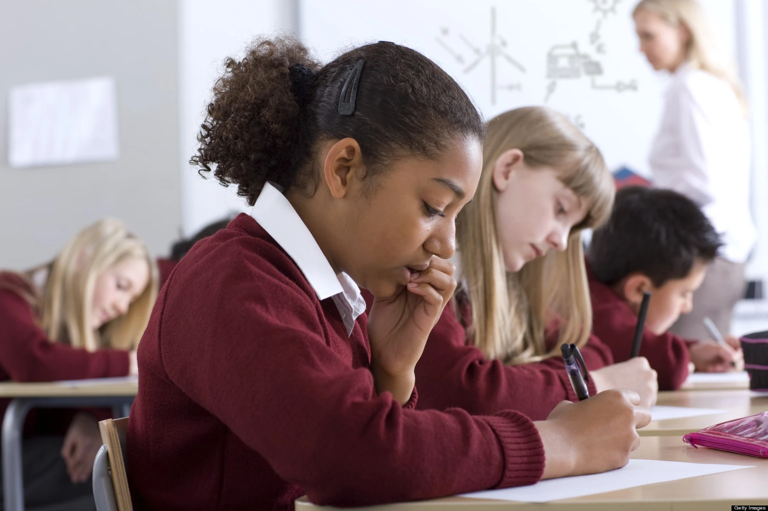 GIRLS-EDUCATION- A teacher exemplifying one of the 10 essential classroom management skills as her class is focused and organised.