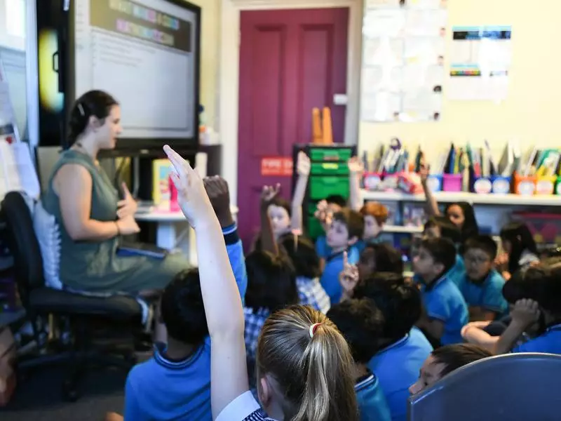 australian classroom A teacher exemplifying one of the 10 essential classroom management skills as her class is focused and organised.