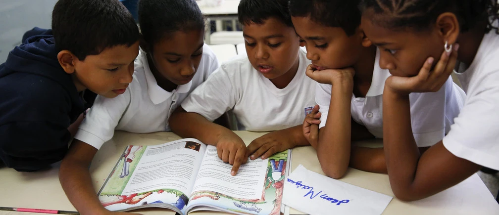 children-reading A teacher exemplifying one of the 10 essential classroom management skills as her class is focused and organised.