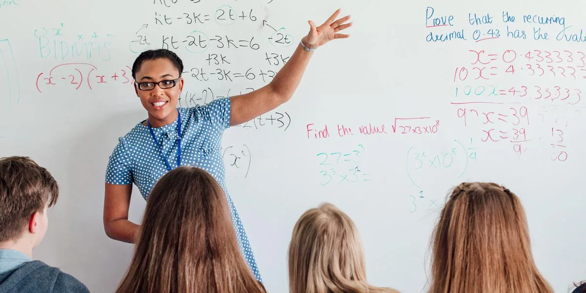 math A teacher exemplifying one of the 10 essential classroom management skills as her class is focused and organised.