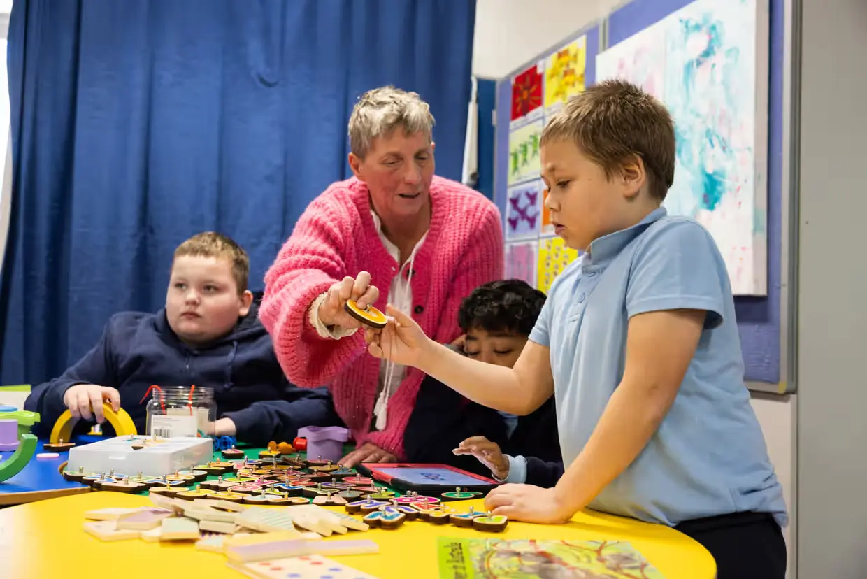 teacher with student A teacher exemplifying one of the 10 essential classroom management skills as her class is focused and organised.