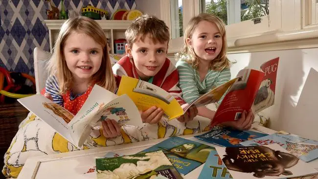 kids reading A teacher exemplifying one of the 10 essential classroom management skills as her class is focused and organised.